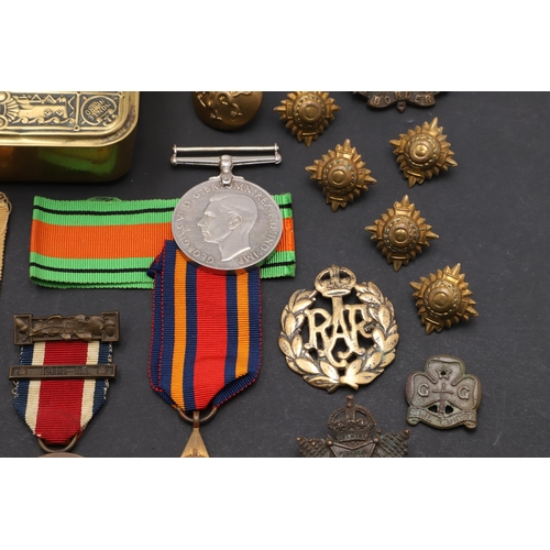 559 - A 1914 CHRISTMAS TIN, SECOND WORLD WAR MEDALS AND A SMALL COLLECTION OF BADGES AND BUTTONS. A First ... 