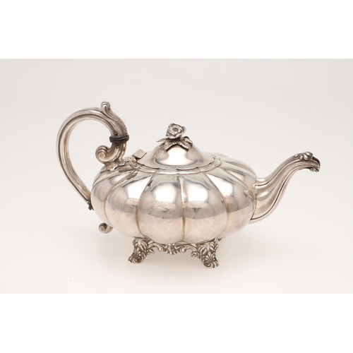 101 - A 19TH CENTURY SILVER TEA POT. of melon fluted form, with a leaf-capped 'C'-scroll handle, a cast fl... 