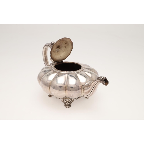 101 - A 19TH CENTURY SILVER TEA POT. of melon fluted form, with a leaf-capped 'C'-scroll handle, a cast fl... 