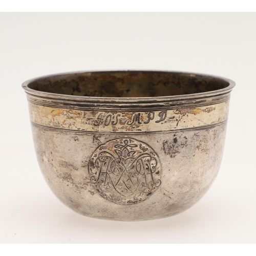 106 - A CONTINENTAL PARCELGILT TUMBLER CUP. circular form, with a domed centre, incised borders,  engraved... 