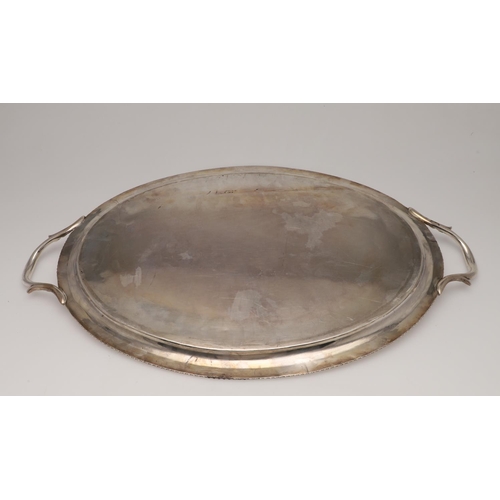 108 - A GEORGE III SILVER TWO-HANDLED TRAY. oval outline, with a gadrooned border, leaf-capped twin handle... 