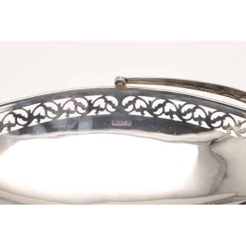 110 - AN EDWARDIAN SILVER SWING-HANDLE BASKET. navette-shaped, with a pierced frieze and raised on a sprea... 