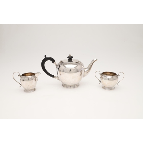 111 - A 20TH CENTURY THREE-PIECE SILVER TEA SET. circular form, with incised borders and scroll handles, b... 