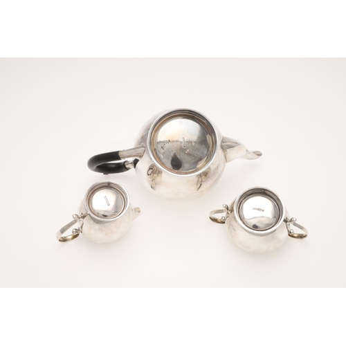 111 - A 20TH CENTURY THREE-PIECE SILVER TEA SET. circular form, with incised borders and scroll handles, b... 