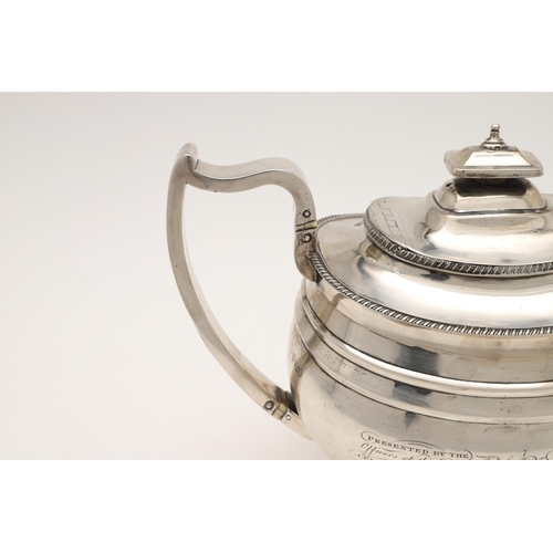 113 - A GEORGE III SILVER TEA POT. rounded oblong form, with gadrooned borders, a cushion finial and on ba... 