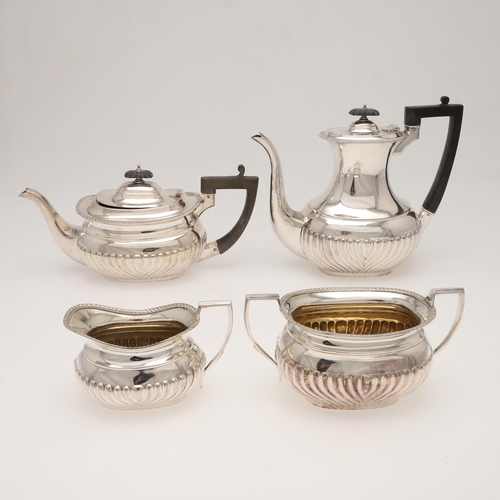 116 - A GEORGE V THREE-PIECE SILVER TEA SET. with rounded oblong bodies, gadrooned borders and part-fluted... 