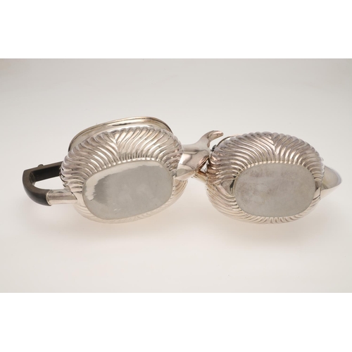 116 - A GEORGE V THREE-PIECE SILVER TEA SET. with rounded oblong bodies, gadrooned borders and part-fluted... 