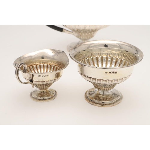 117 - A LATE VICTORIAN BACHELOR'S SILVER TEA SET. circular form, with bats-wing fluted decoration, scroll ... 