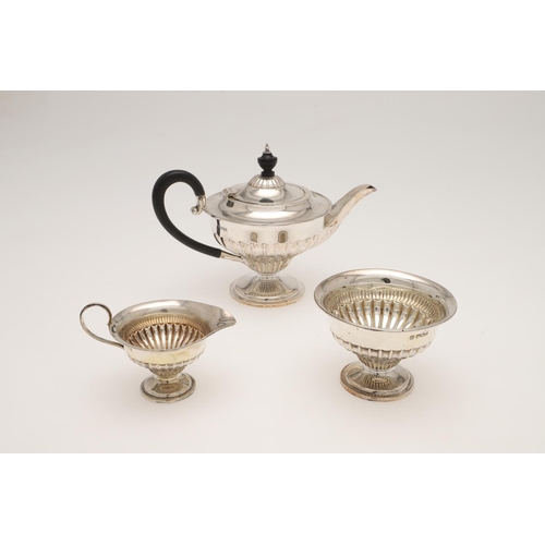 117 - A LATE VICTORIAN BACHELOR'S SILVER TEA SET. circular form, with bats-wing fluted decoration, scroll ... 