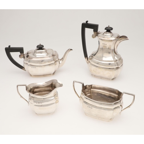 124 - A GEORGE V FOUR-PIECE SILVER TEA SET. shaped rectangular outline, with angular handles and flat base... 