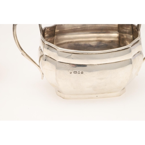 124 - A GEORGE V FOUR-PIECE SILVER TEA SET. shaped rectangular outline, with angular handles and flat base... 