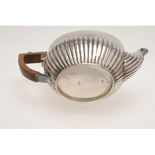 126 - A LATE VICTORIAN THREE-PIECE SILVER TEA SET. of oval outline, with angular handles and part-fluted b... 