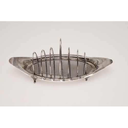 127 - A LATE VICTORIAN SILVER TOAST RACK. boat-shaped, with seven arched bars and a central handle, by Atk... 