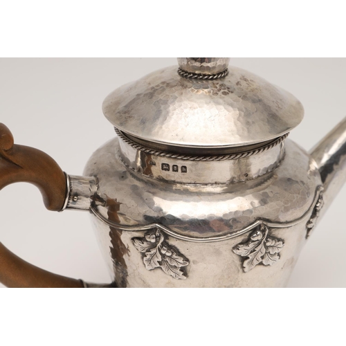 143 - AN ARTS & CRAFTS THREE PIECE SILVER TEA SET, BY AMY SANDHEIM. tapering circular form, with corded bo... 