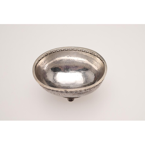 144 - AN ARTS & CRAFTS SILVER BOWL, BY AMY SANDHEIM. of oval form, with Celtic band borders, a spot-hammer... 