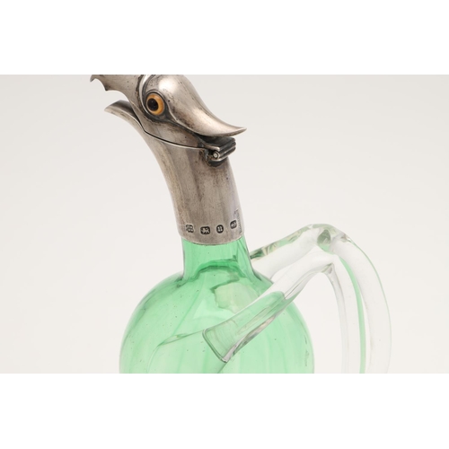 151 - A LATE VICTORIAN SILVER MOUNTED GREEN GLASS NOVELTY LIQUEUR FLASK. modelled with an eagles head, col... 