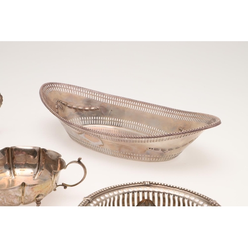 155 - AN EDWARDIAN SILVER BREAD BASKET. of navette outline, with a  punch bead border, pierced sides and e... 