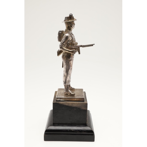 170 - A GEORGE VI SILVER FIGURE OF A SOLDIER, realistically modelled in full uniform, raised on a textured... 