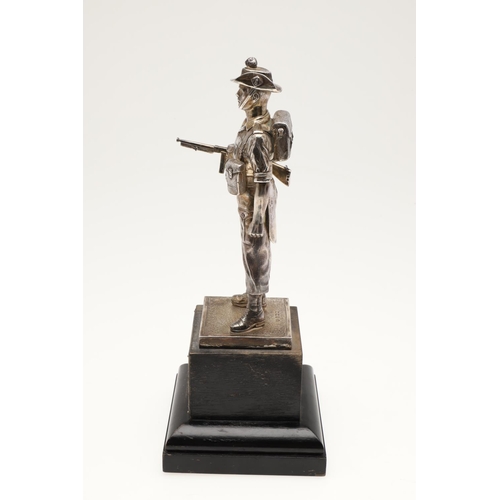 170 - A GEORGE VI SILVER FIGURE OF A SOLDIER, realistically modelled in full uniform, raised on a textured... 