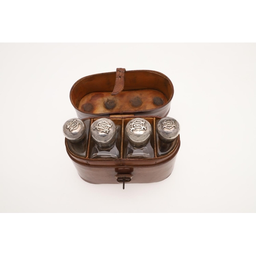 178 - AN EDWARDIAN SCENT/ TOILET WATER SET. with four silver mounted cut-glass bottles, each with applied ... 