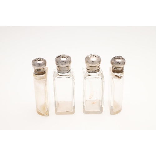 178 - AN EDWARDIAN SCENT/ TOILET WATER SET. with four silver mounted cut-glass bottles, each with applied ... 