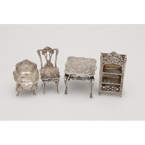 192 - SILVER MINIATURES OR TOYS. 5 chairs, 2 tables, a matched three-piece tea set, a bookcase, a candlest... 