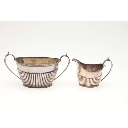 47 - A LATE VICTORIAN FOUR-PIECE SILVER TEA & COFFEE SERVICE. of oval form, with scroll handles and the b... 