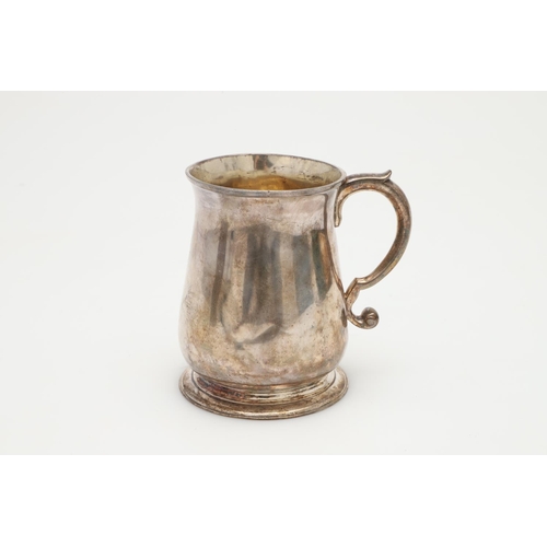 48 - A GEORGE II SILVER BALUSTER MUG. with an 'S'-scroll handle and a spreading circular foot, gilt inter... 