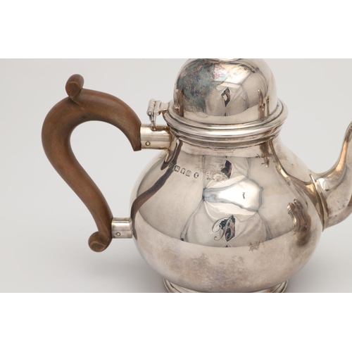 69 - A GEORGE V THREE-PIECE SILVER TEA SET. of baluster form, with scroll handles, on spreading circular ... 