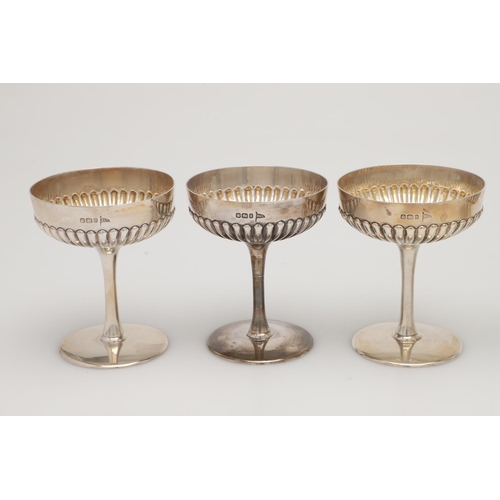 70 - A CASED SET OF SIX LATE VICTORIAN SILVER CHAMPAGNE GOBLETS. the lower halves of the bowls with embos... 