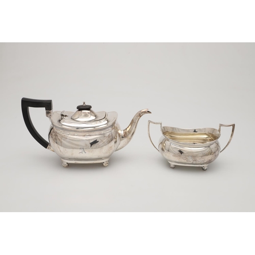 71 - A GEORGE V THREE-PIECE SILVER TEA SET. with rounded oblong bodies, reeded borders and on ball feet, ... 