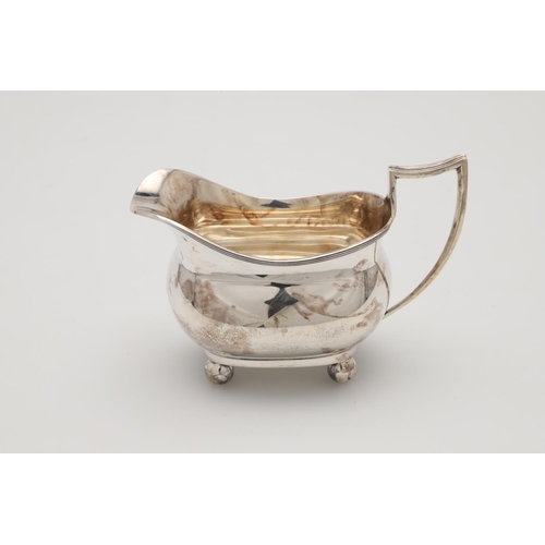 71 - A GEORGE V THREE-PIECE SILVER TEA SET. with rounded oblong bodies, reeded borders and on ball feet, ... 