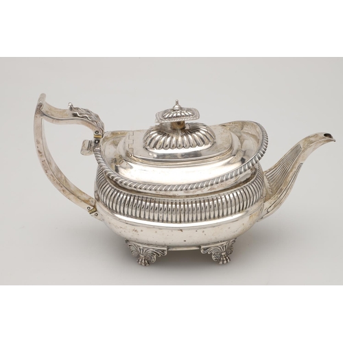 74 - A GEORGE IV THREE-PIECE SILVER TEA SET. with rounded oblong bodies, gadrooned borders,  fluted decor... 