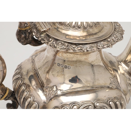 75 - A GEORGE IV SILVER COFFEE POT. with an embossed lobed body, a waisted neck, decorated with an applie... 