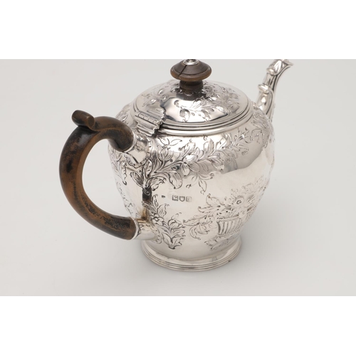 79 - A LATE VICTORIAN SMALL SILVER TEA POT. with an oviform body, embossed & chased decoration, a wooden ... 