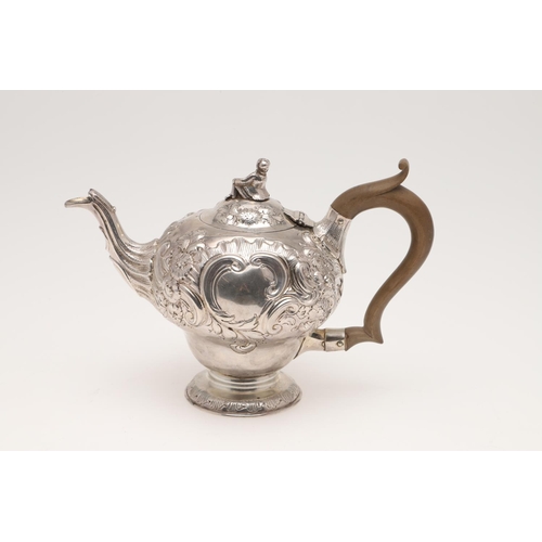 86 - A GEORGE III SILVER TEA POT. inverted baluster form, with a figural finial, scroll handle and later ... 