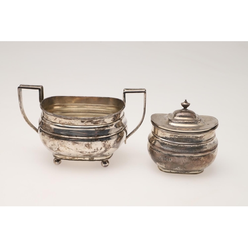 94 - A GEORGE V SILVER TEA POT & MATCHING SUGAR BASIN. rounded rectangular form, with angular handles and... 