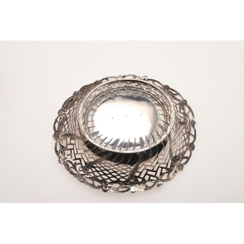 96 - A GEORGE III SILVER SWING-HANDLED SWEETMEAT BASKET. shaped oval outline, with pierced sides, embosse... 