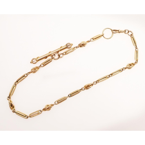 505 - A GOLD WATCH CHAIN. formed with fancy long and short links, to a clip and bolt clasp, suspending a f... 