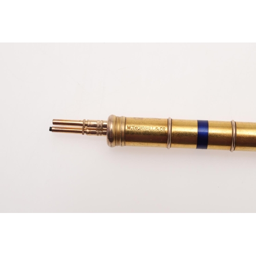 516 - A GOLD AND ENAMEL PROPELLING PENCIL BY W. THORNHILL & CO. with black, red and blue enamel decoration... 