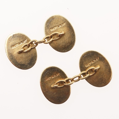 525 - A PAIR OF 18CT GOLD AND PLATUNUM CUFFLINKS. of oval-shape, the central panel of platinum with engine... 