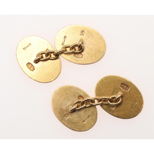 526 - A PAIR OF 18CT GOLD CUFFLINKS. of oval shape, each with engine turned decoration and engraved with a... 