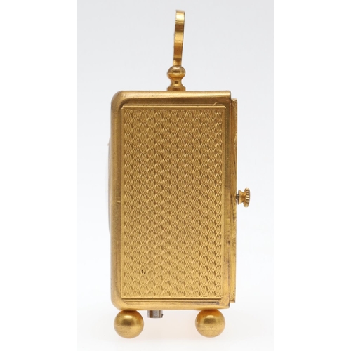 858 - A FRENCH MINIATURE GILT METAL TRAVELLING TIMEPIECE. late 19th/early 20th century, the case with carr... 