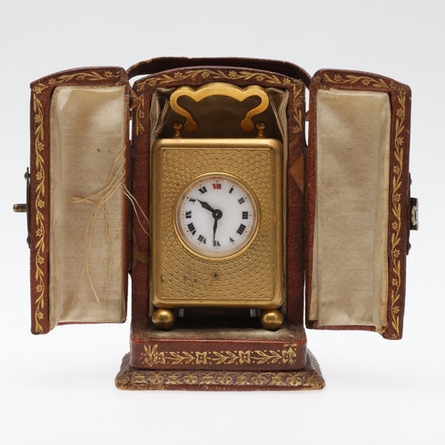 858 - A FRENCH MINIATURE GILT METAL TRAVELLING TIMEPIECE. late 19th/early 20th century, the case with carr... 