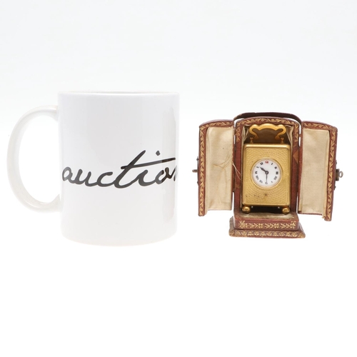 858 - A FRENCH MINIATURE GILT METAL TRAVELLING TIMEPIECE. late 19th/early 20th century, the case with carr... 