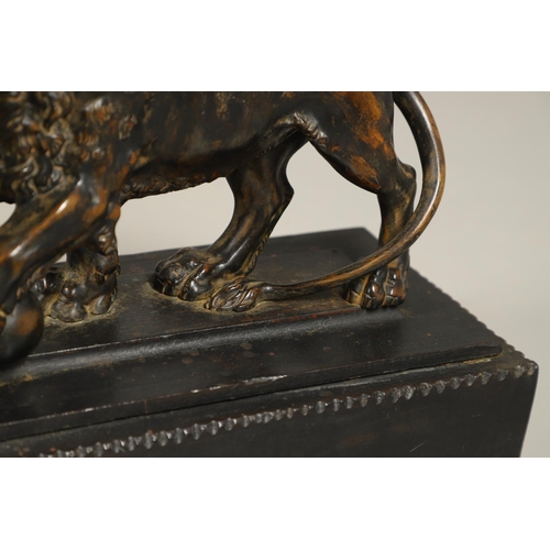 882 - A GRAND TOUR BRONZE OF THE MEDICI LION. 18th/19th century, well worn brown patina, upon later ebonis... 