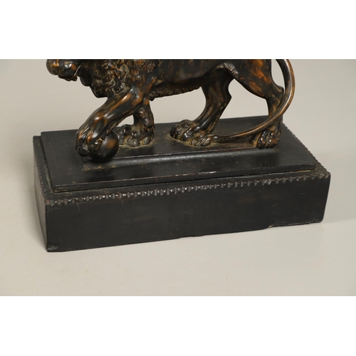 882 - A GRAND TOUR BRONZE OF THE MEDICI LION. 18th/19th century, well worn brown patina, upon later ebonis... 