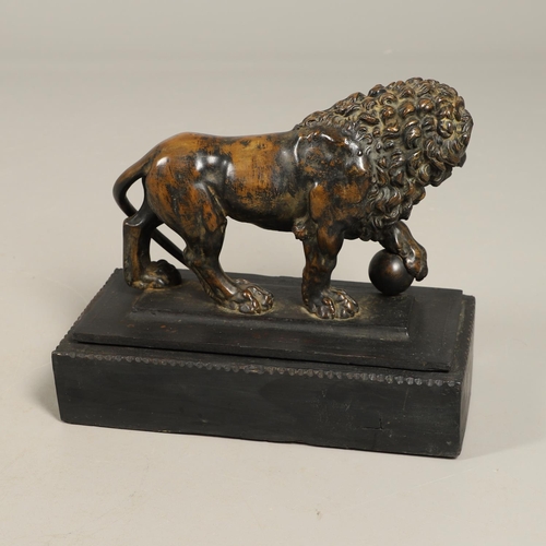 882 - A GRAND TOUR BRONZE OF THE MEDICI LION. 18th/19th century, well worn brown patina, upon later ebonis... 