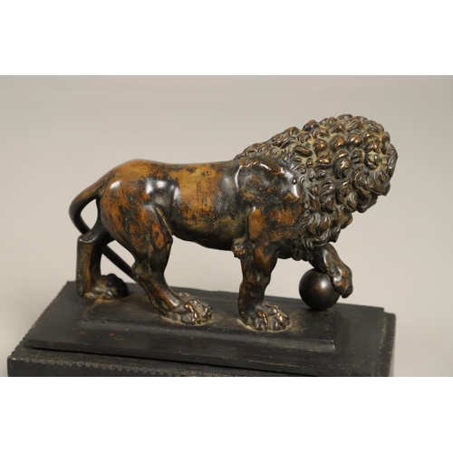 882 - A GRAND TOUR BRONZE OF THE MEDICI LION. 18th/19th century, well worn brown patina, upon later ebonis... 