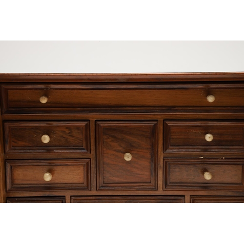 890 - A 19TH CENTURY WALNUT TABLE TOP COLLECTOR'S CABINET. the doors with brass sliding locks enclosing ni... 